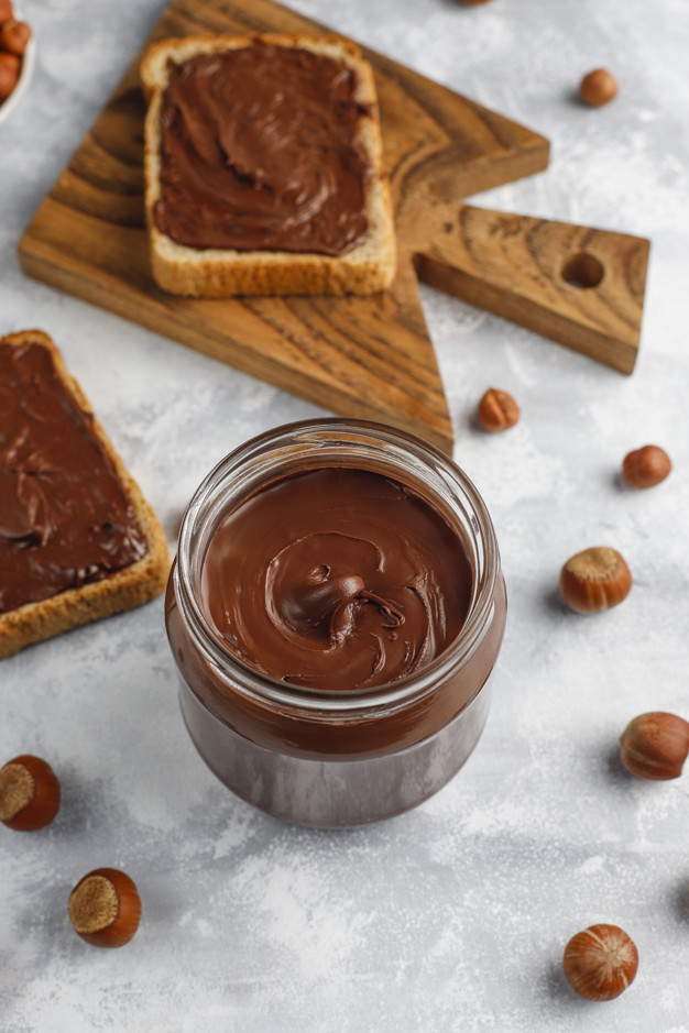 chocolate-spread-or-nougat-cream-with-hazelnuts-in-glass-jar-on
